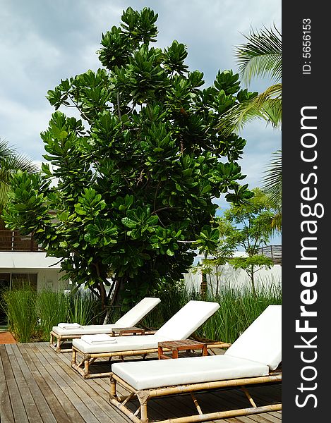 White trestle-beds near the resort's pool