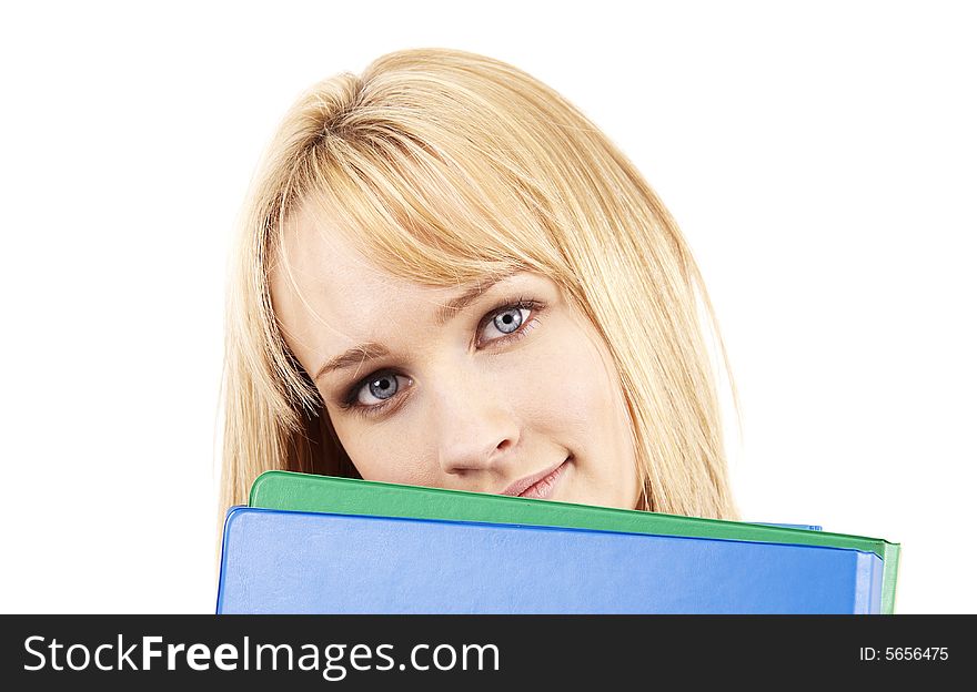 Beautiful blonde businesswoman holding green and blue files by her face. Isolated on white background. Beautiful blonde businesswoman holding green and blue files by her face. Isolated on white background