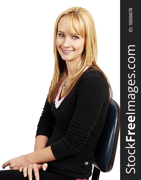 Beautiful blonde businesswoman sitting on a blue office chair. Isolated on white background. Beautiful blonde businesswoman sitting on a blue office chair. Isolated on white background
