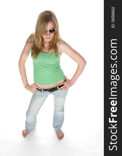 Pretty teenage girl with sunglasses and hands on her hips from above