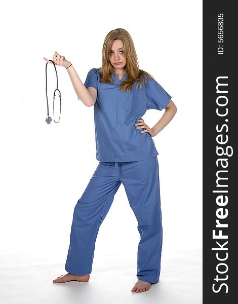 Lady doctor holding stethoscope on one finger and her hand on hip