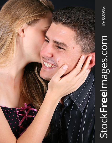 Young couple, sweet secret whispers with a big smile