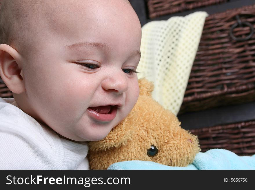 Six month old baby sitting infront of wooden drawers. Six month old baby sitting infront of wooden drawers