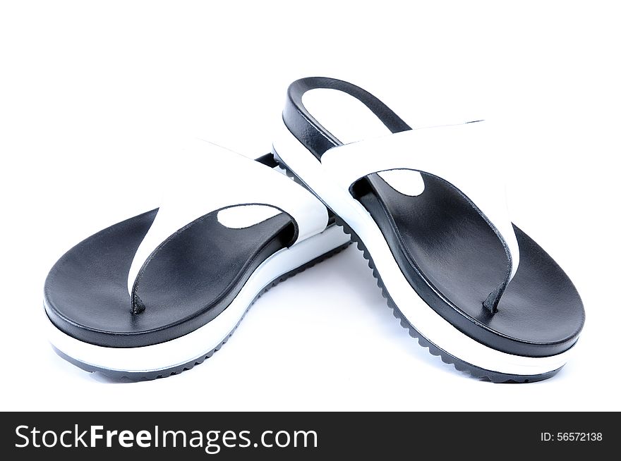 Leather flip flops photographed in studio on white background