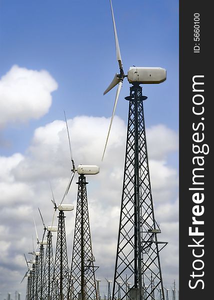 Group of windturbines over sky background