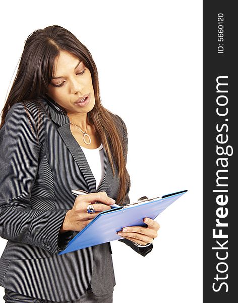 Beautiful brunette woman in pinstripe suit holding her clipboard while talking on her cellphone. Isolated on white background with copy space. Beautiful brunette woman in pinstripe suit holding her clipboard while talking on her cellphone. Isolated on white background with copy space