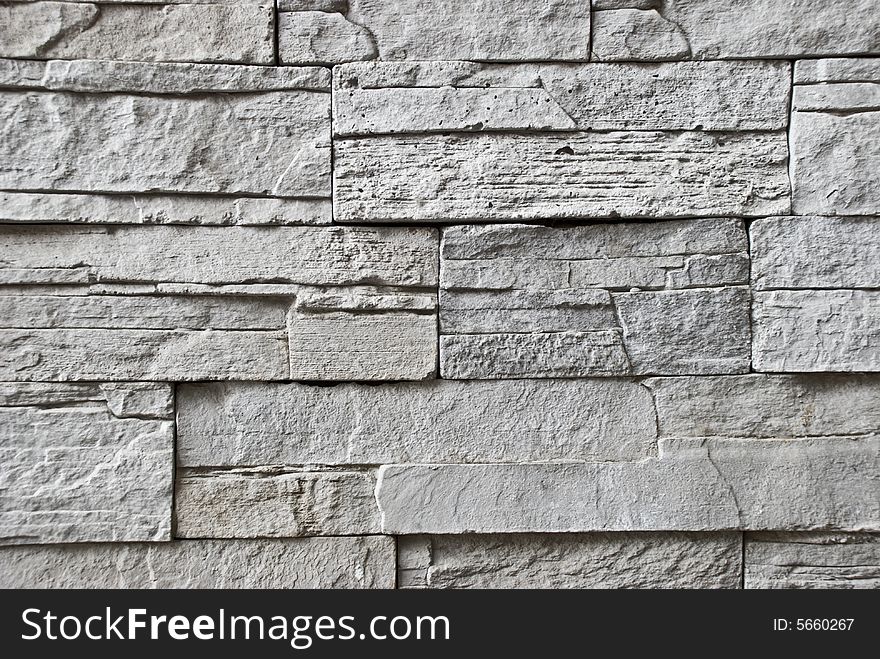 A wall made of grey stone bricks. A wall made of grey stone bricks