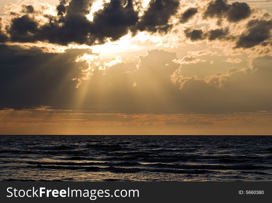 The sea, clouds and solar beams
