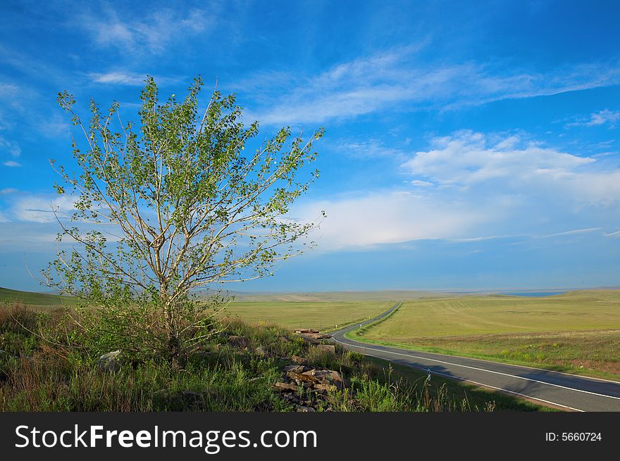 Landscape  road, clouds and the blue sky