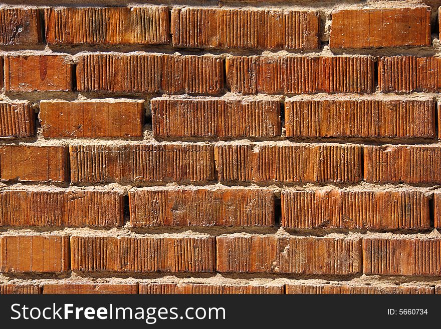 Wall with bright saturated orange bricks. Wall with bright saturated orange bricks