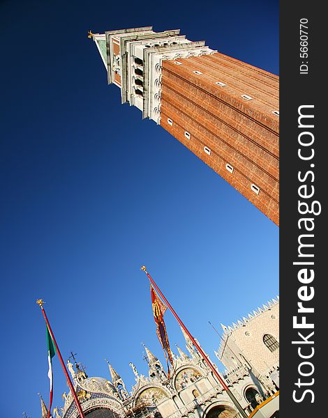 A dynamic view of Saint Mark cathedral and its towerin Saint Mark square in Venice, Italy. A dynamic view of Saint Mark cathedral and its towerin Saint Mark square in Venice, Italy