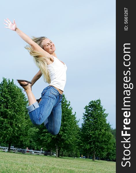 Happy jumping woman in the park. Happy jumping woman in the park.