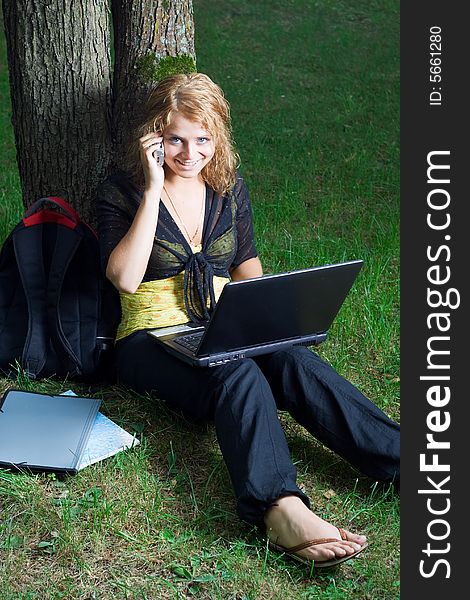 Student girl with laptop in the park. Student girl with laptop in the park.