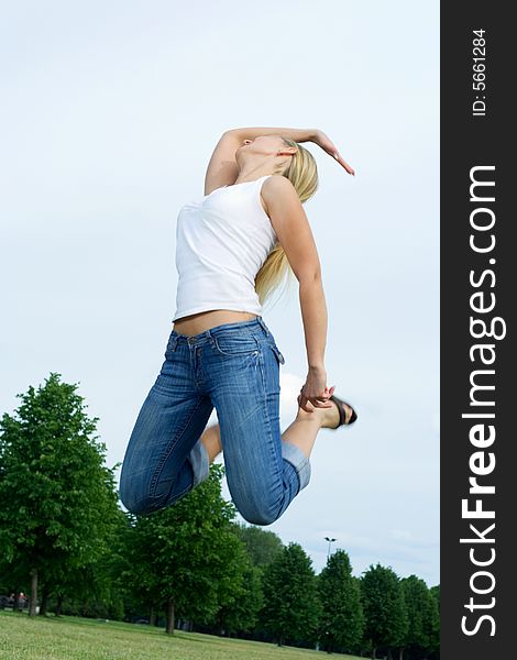 Happy jumping woman in the park. Happy jumping woman in the park.