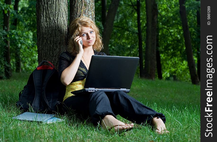 Student girl with laptop in the park. Student girl with laptop in the park.