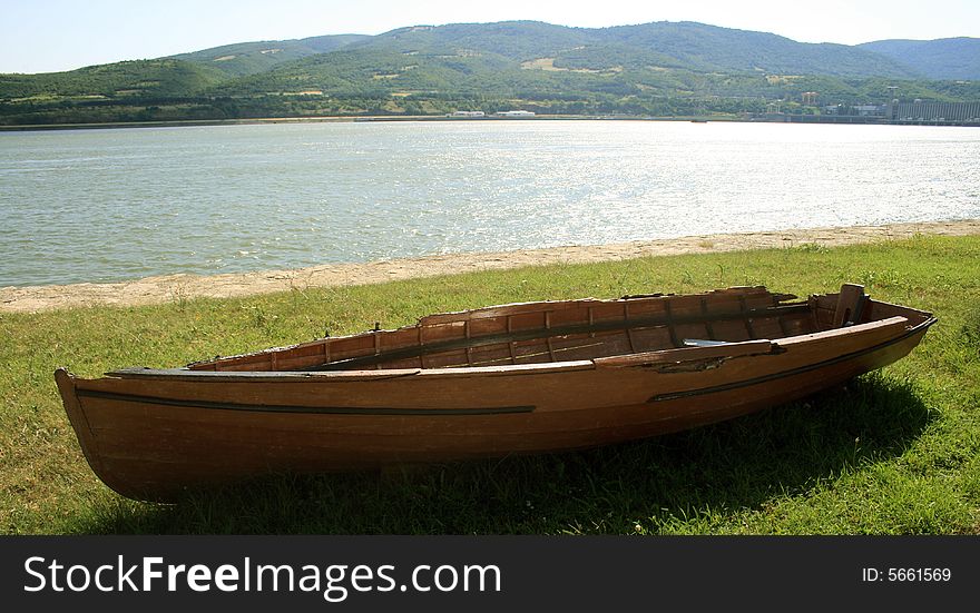 An old wooden boat laying on land. An old wooden boat laying on land