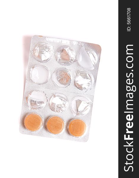 Closeup view of orange pills in plastic blister