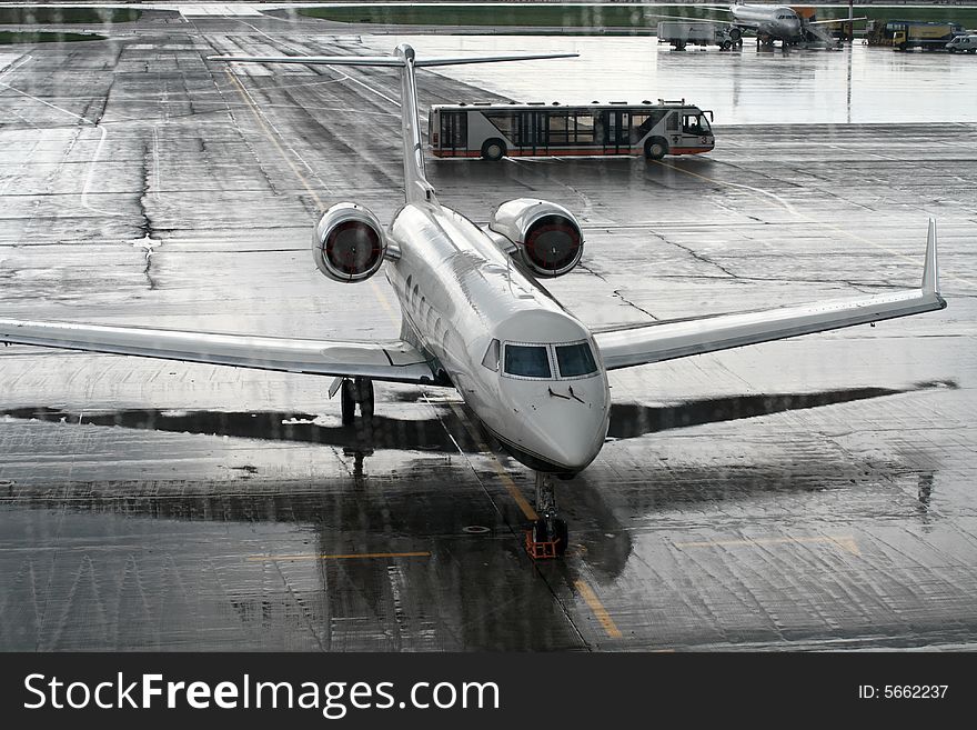 The airliner behind the window in a rainy day