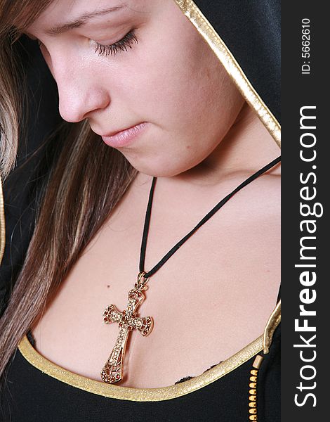The sad girl with a precious Christian cross. The sad girl with a precious Christian cross