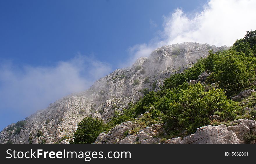 Rocky cliffs and clouds in Biokovo mountains in Dalmatia, Croatia. Rocky cliffs and clouds in Biokovo mountains in Dalmatia, Croatia