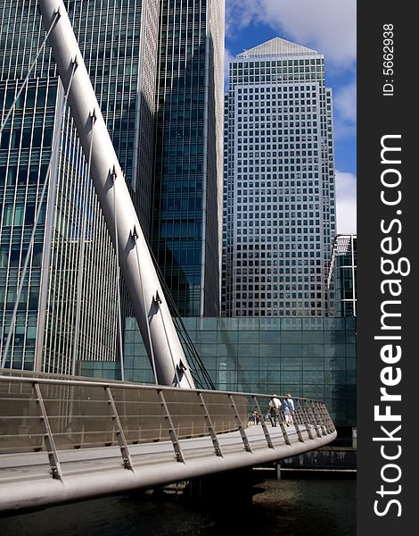 Crossing over pedestrian bridge with office complex in background