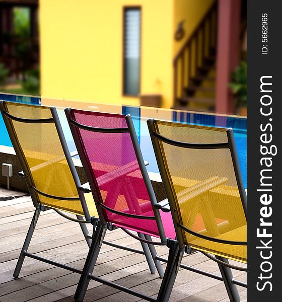 Color   deckchairs,  by the pool