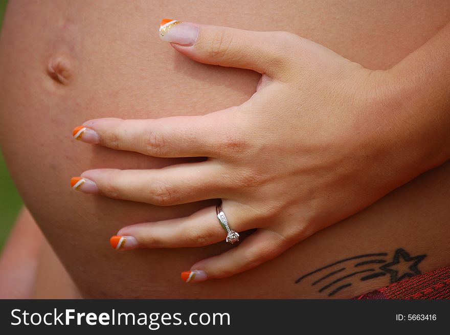 A pregnant mum holds her tummy with tender love. A pregnant mum holds her tummy with tender love