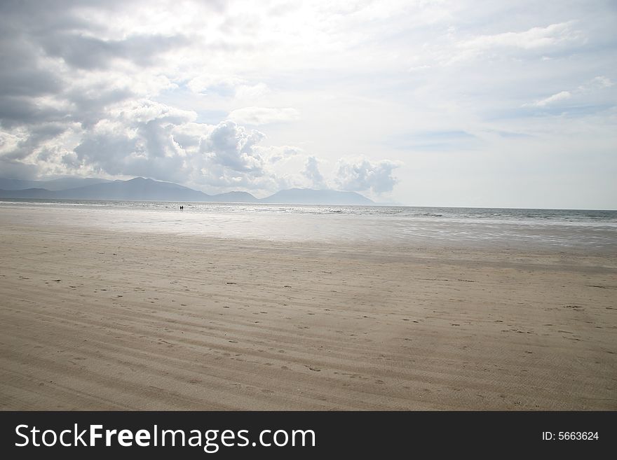 Two people walking on a beach. Two people walking on a beach