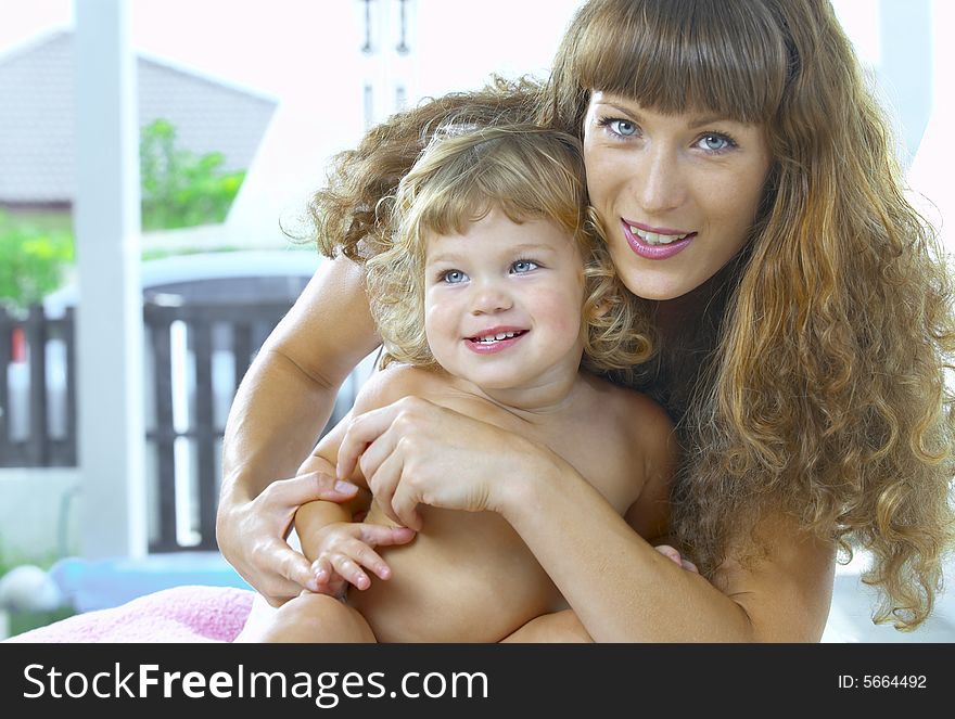 High key portrait of happy mother with baby. High key portrait of happy mother with baby