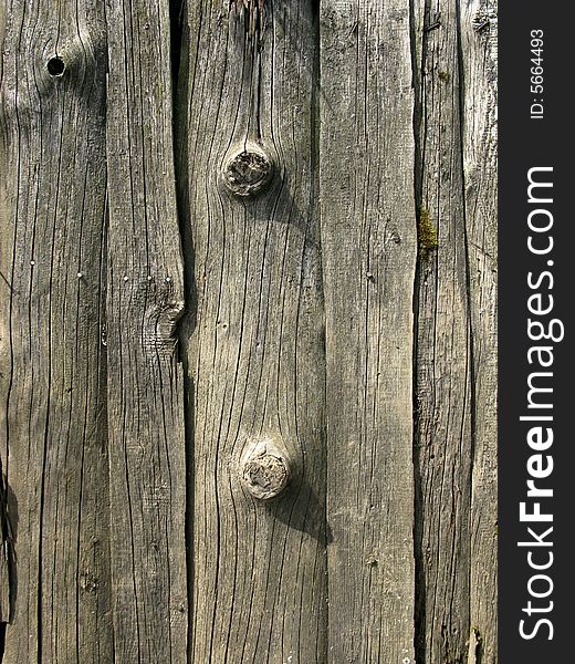 Fragment of old destroyed wooden uncolored fence. Fragment of old destroyed wooden uncolored fence