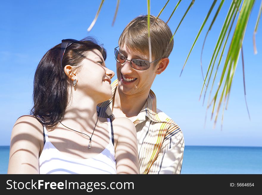 A portrait of attractive couple having date on the beach. A portrait of attractive couple having date on the beach