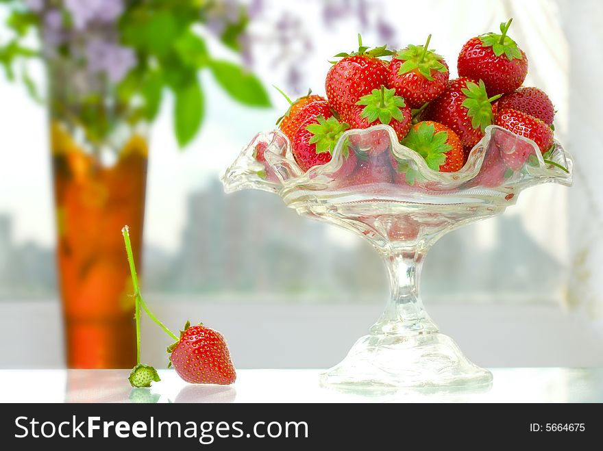 High key photo of fruit dish filled with nice red strawberries. High key photo of fruit dish filled with nice red strawberries