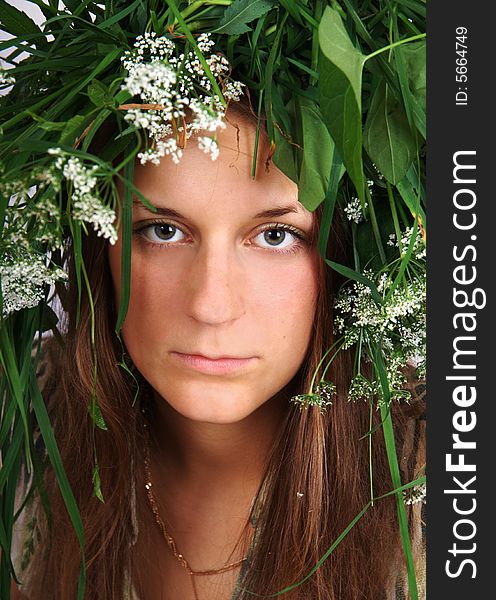 Girl with crown of grass and flowers