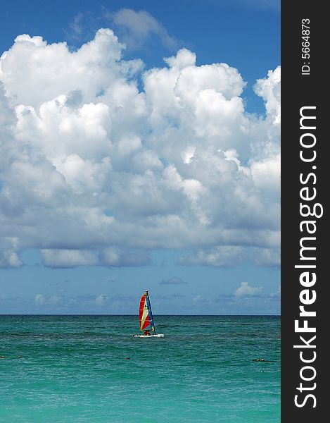 Beach in the Caribbean with a catamaran in a stormy summer afternoon