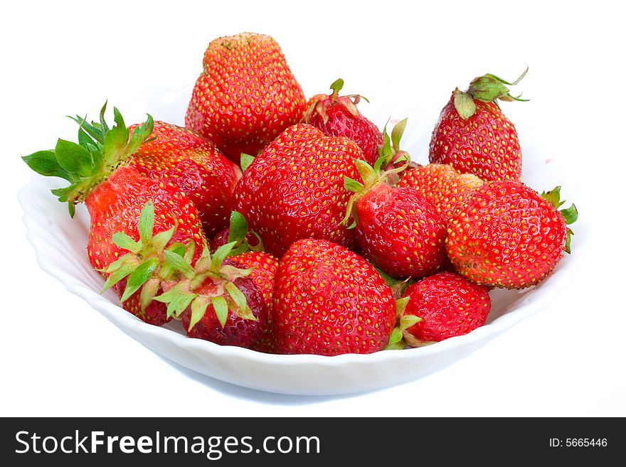 Close-up of ripe strawberries on plate, isolated over white background