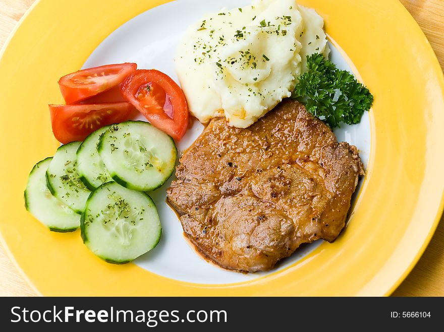 Barbecue with steaks of pork,puree potatoes,salad.