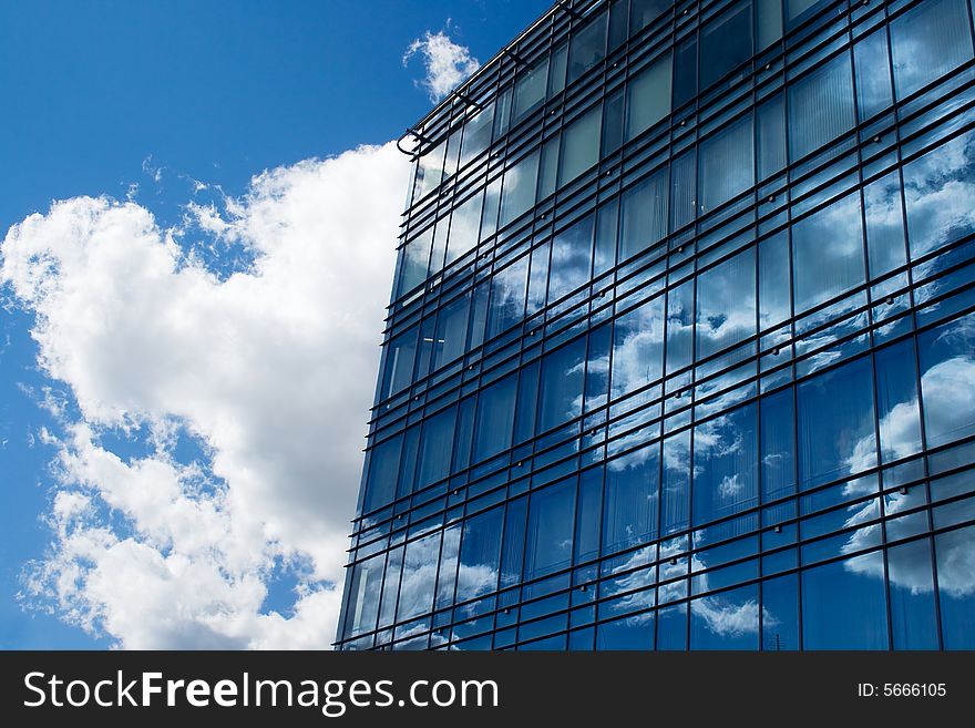 A view of office building windows reflecting the sky and clouds. A view of office building windows reflecting the sky and clouds