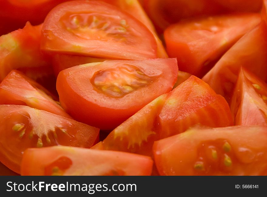 Fresh cut quarters of tomatoes close up. Fresh cut quarters of tomatoes close up.