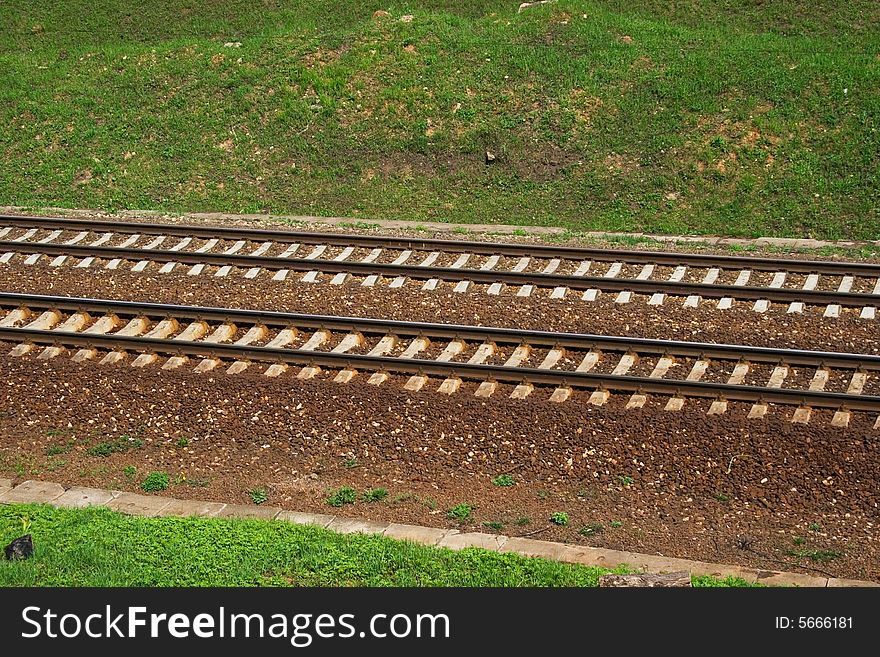 A pair railroad tracks on a sunny day. A pair railroad tracks on a sunny day