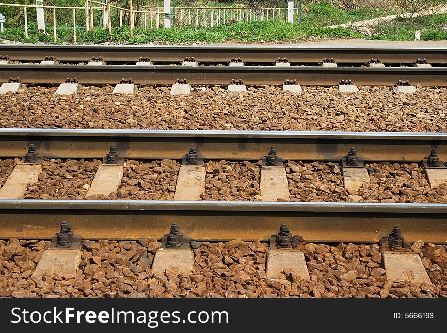 A pair railroad tracks on a sunny day. A pair railroad tracks on a sunny day