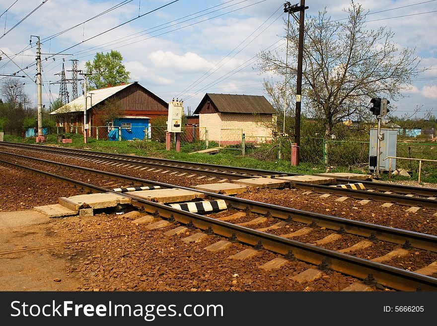 A railroad pedestrian crossing with light signals. A railroad pedestrian crossing with light signals