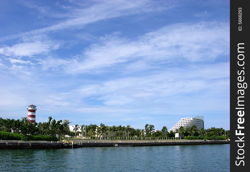 The view of Our Lucaya town lighthouse and the resort building on Grand Bahama Island, The Bahamas. The view of Our Lucaya town lighthouse and the resort building on Grand Bahama Island, The Bahamas.