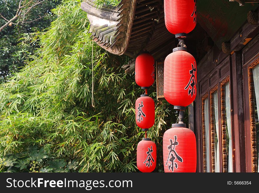 Red  chinese lantern hung before old building.chinese word 'tea' write on the lantern.