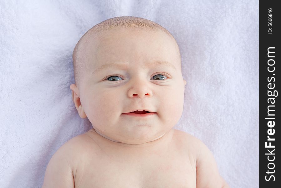 Little Baby Smiling Laying on a Blanket Naked