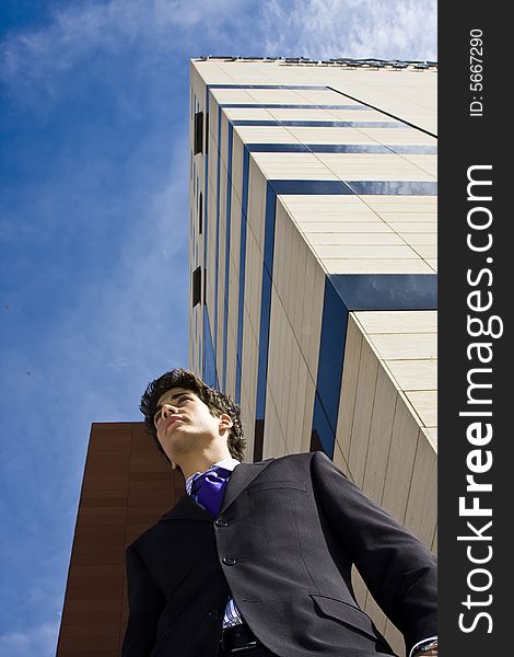 Young businessman portrait against urban background