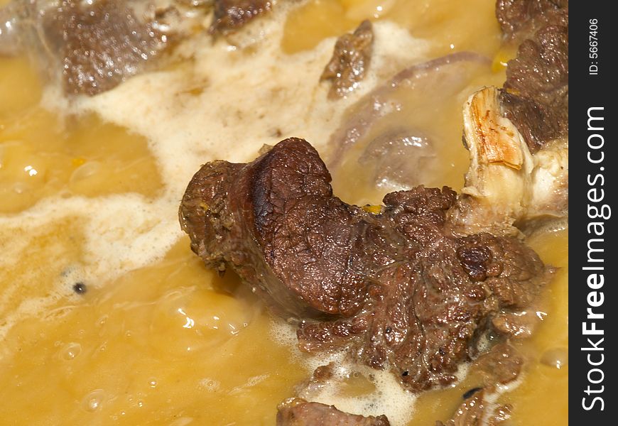 Close-up of meat at boiling sauce. Close-up of meat at boiling sauce