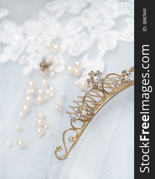 Wedding diadem on white veil background. Wedding diadem on white veil background