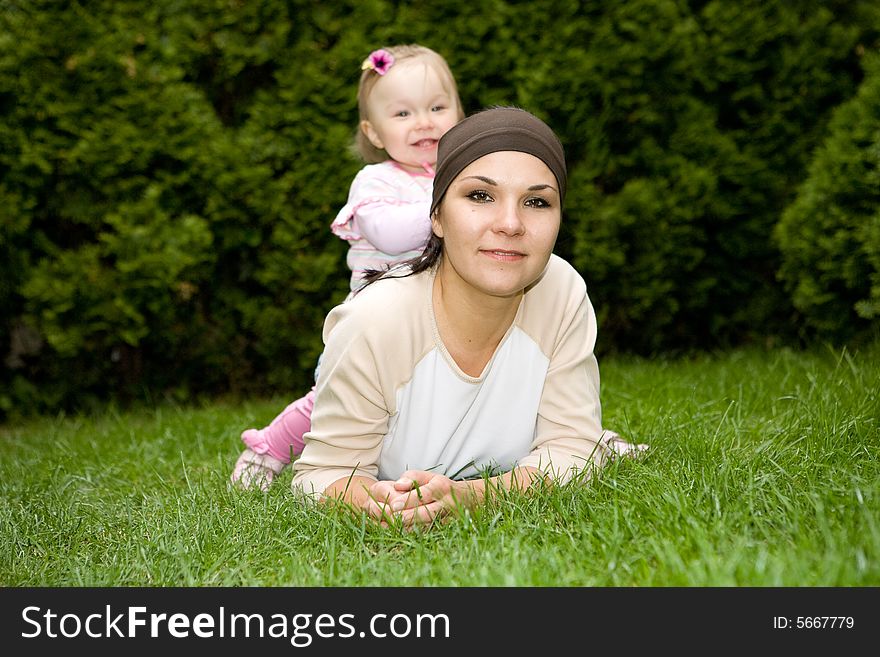 Happy family relaxing on grass. Happy family relaxing on grass