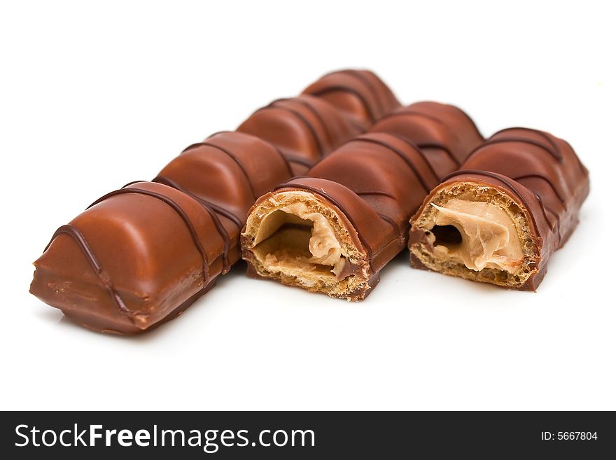Milk chocolate bars covered wafer on white background.