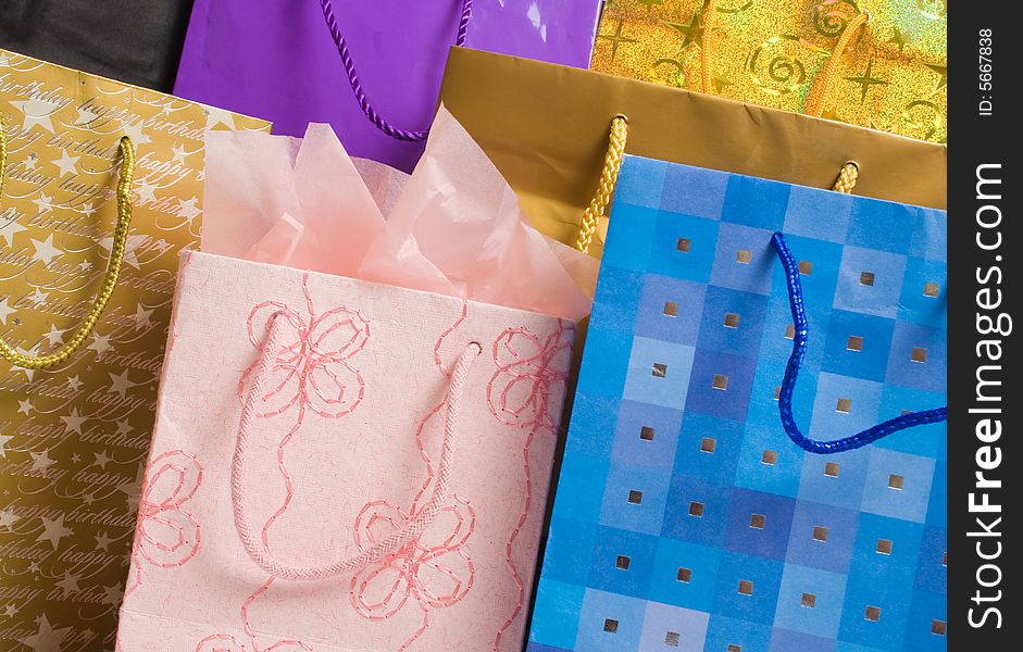 Collection of gift bags in different colors and patterns.